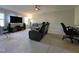 Bright living room with plush carpet, comfortable seating, and a large entertainment center at 120 Putters Ct, Durham, NC 27703