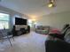 Cozy living room featuring a TV, comfortable sofas, and natural light from the windows at 120 Putters Ct, Durham, NC 27703
