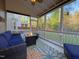 Relaxing screened porch with comfortable seating and a fire pit table at 120 Putters Ct, Durham, NC 27703
