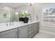 Bathroom with double sink vanity, large mirror, and a window, providing ample light and space at 1203 Great Egret Way, Durham, NC 27713