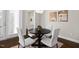 Bright dining area offers a dark wood table, modern chandelier, and stylish decor for enjoyable meals at 1203 Great Egret Way, Durham, NC 27713
