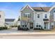 Charming townhome showcases a stone facade and neutral color palette, providing a welcoming curb appeal at 1203 Great Egret Way, Durham, NC 27713