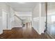 Bright foyer features hardwood flooring, white wainscoting, and stairway leading to upper level at 1203 Great Egret Way, Durham, NC 27713