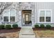 Inviting front entrance of home featuring decorative stone, manicured landscaping, and a modern front door at 1203 Great Egret Way, Durham, NC 27713