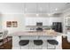 Elegant kitchen features a large center island, white cabinets, pendant lights and stainless steel appliances at 1203 Great Egret Way, Durham, NC 27713