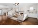 Spacious living room features hardwood floors, fireplace, and stairway; perfect for entertaining and relaxation at 1203 Great Egret Way, Durham, NC 27713