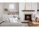 Bright living room showcases a fireplace with a wood mantel, neutral paint, and an area rug adding warmth and style at 1203 Great Egret Way, Durham, NC 27713