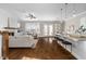 Open-concept living area showcases the living room, kitchen island with bar stools, and dining area for seamless living at 1203 Great Egret Way, Durham, NC 27713