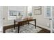 Bright home office featuring a dark wood desk, natural light, and neutral decor for a productive workspace at 1203 Great Egret Way, Durham, NC 27713