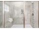 Walk-in shower with tiled walls, glass door, built-in niche, and modern fixtures at 1203 Great Egret Way, Durham, NC 27713
