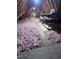 Bright unfinished attic with insulation and storage shelves, offering potential for customization at 1208 Goodwin Rd, Apex, NC 27523