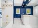 Bathroom with vanity, bathtub and shower, white tile, and blue walls at 1208 Goodwin Rd, Apex, NC 27523