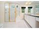 Bathroom features gold fixtures, white cabinets, marble countertops, and tiled floors at 1208 Goodwin Rd, Apex, NC 27523