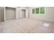Bright bedroom featuring ample closet space, natural light, and unfinished floors ready for new finishes at 1208 Goodwin Rd, Apex, NC 27523