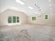 Unfinished bonus room with many windows, lights and vaulted ceiling at 1208 Goodwin Rd, Apex, NC 27523