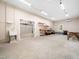 Spacious garage with ample storage, workshop area, and access to additional garage space at 1208 Goodwin Rd, Apex, NC 27523