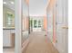 Hallway that leads to a bedroom with floral curtains and large windows at 1208 Goodwin Rd, Apex, NC 27523