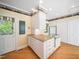Kitchen featuring white cabinetry, granite counters, and an island with a cooktop at 1208 Goodwin Rd, Apex, NC 27523