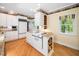 Traditional kitchen with white cabinets, granite countertops, and modern appliances at 1208 Goodwin Rd, Apex, NC 27523