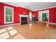 Inviting living room with a fireplace, hardwood floors, and large windows at 1208 Goodwin Rd, Apex, NC 27523