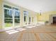 Spacious living room with large windows offering beautiful views and tile flooring at 1208 Goodwin Rd, Apex, NC 27523