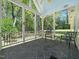 Relaxing screened-in patio with tiled floors and scenic backyard views at 1208 Goodwin Rd, Apex, NC 27523