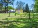 Scenic property featuring a storage shed, grape vines, and lush greenery at 1208 Goodwin Rd, Apex, NC 27523