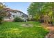 Expansive backyard features lush lawn, mature trees, and a cozy fire pit area, perfect for outdoor entertaining at 1216 Caribou Xing, Durham, NC 27713