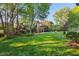 Beautiful, expansive backyard with a fire pit, lush lawn, and mature trees offers a private outdoor retreat at 1216 Caribou Xing, Durham, NC 27713
