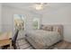 Cozy bedroom with hardwood floors, chair rail, and two windows, bathed in natural light at 1216 Caribou Xing, Durham, NC 27713