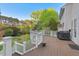 Spacious deck with a grill perfect for outdoor dining, complemented by landscaped backyard and surrounding trees at 1216 Caribou Xing, Durham, NC 27713