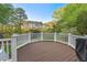 View of the Deck offering a glimpse of the surrounding trees and a grill for barbecuing at 1216 Caribou Xing, Durham, NC 27713