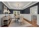 Elegant dining room with dark walls, wainscoting, hardwood floors, and access to the porch at 1216 Caribou Xing, Durham, NC 27713