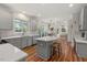 Bright kitchen featuring a center island, modern appliances, and an open view to the dining room and living room at 1216 Caribou Xing, Durham, NC 27713