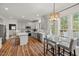 Bright kitchen features stainless appliances, light gray cabinets, stylish backsplash, and access to dining area at 1216 Caribou Xing, Durham, NC 27713