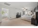 Spacious main bedroom with a ceiling fan, walk-in closet, and an ensuite bathroom with a soaking tub at 1216 Caribou Xing, Durham, NC 27713