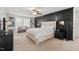Spacious main bedroom with dark accent wall, ceiling fan, and carpeted floors at 1216 Caribou Xing, Durham, NC 27713