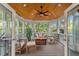 Enclosed porch with wood ceiling, comfortable seating, and views of the lush backyard at 1216 Caribou Xing, Durham, NC 27713
