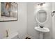 A well-lit powder room features stylish fixtures and an attractive mirror at 1216 Caribou Xing, Durham, NC 27713