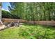 Spacious backyard features a well-maintained lawn, patio area, and wooded backdrop at 12433 N Exeter Way, Durham, NC 27703