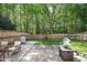 Backyard featuring a patio, outdoor seating, lush green lawn, and privacy fence at 12433 N Exeter Way, Durham, NC 27703