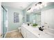 Bathroom with double vanity, framed mirrors, and walk-in shower offering ample space and functionality at 12433 N Exeter Way, Durham, NC 27703