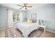 Bright bedroom features a ceiling fan, geometric rug and natural light at 12433 N Exeter Way, Durham, NC 27703