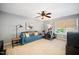 Cozy bonus room features a comfortable sofa, exercise bike and ceiling fan at 12433 N Exeter Way, Durham, NC 27703