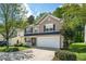 Charming two-story home featuring a 2-car garage, manicured lawn, and covered front porch at 12433 N Exeter Way, Durham, NC 27703