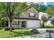 Charming two-story home featuring a 2-car garage, manicured lawn, and covered front porch at 12433 N Exeter Way, Durham, NC 27703