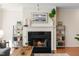Elegant fireplace with a black mantel, flanked by bookshelves, enhancing the living room's ambiance at 12433 N Exeter Way, Durham, NC 27703