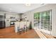 Bright kitchen featuring stainless steel appliances, a breakfast bar, and sliding glass doors to the patio at 12433 N Exeter Way, Durham, NC 27703