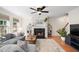 Inviting living room with a fireplace, hardwood floors, and natural light from the window at 12433 N Exeter Way, Durham, NC 27703