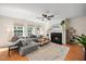 Spacious living room featuring a fireplace, a ceiling fan, and comfortable seating for entertaining guests at 12433 N Exeter Way, Durham, NC 27703